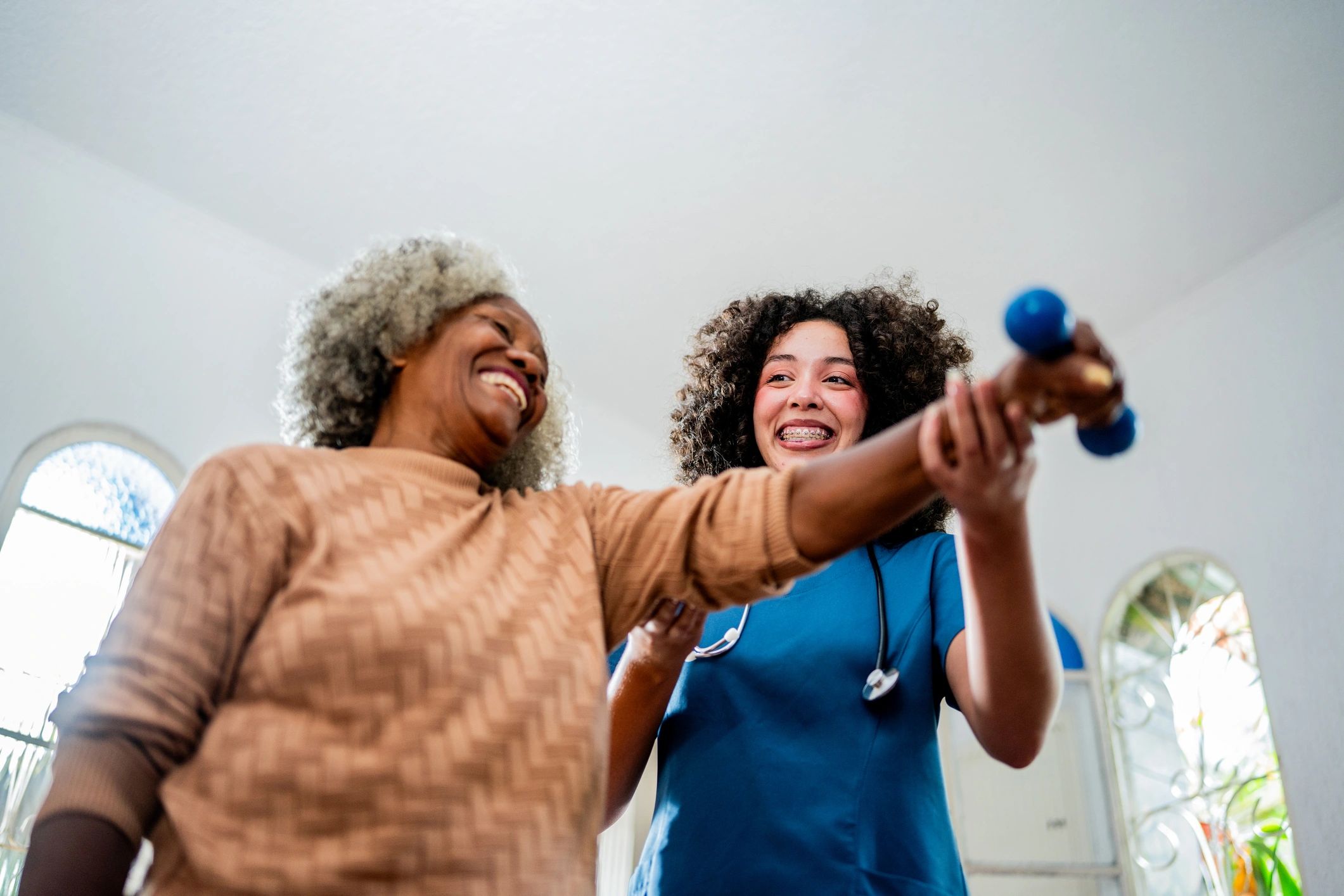 Physical therapist supporting a patient with guided exercise